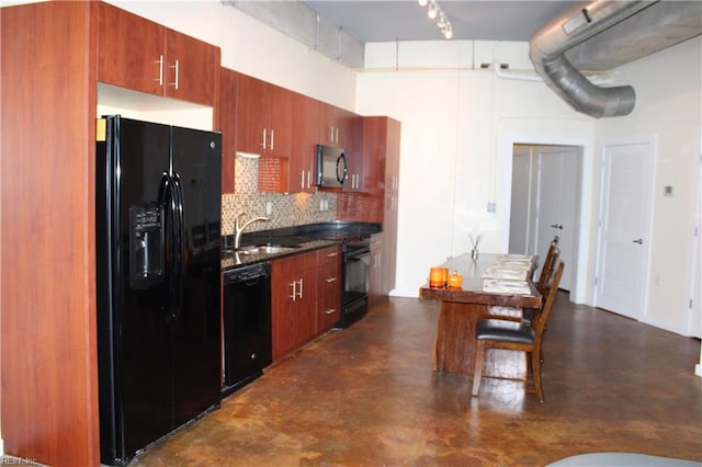 kitchen featuring backsplash, black appliances, sink, and track lighting