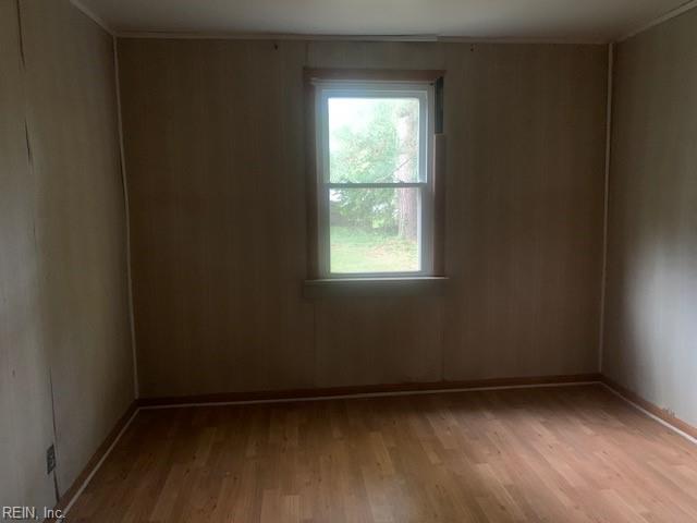 empty room with a wealth of natural light and light wood-type flooring