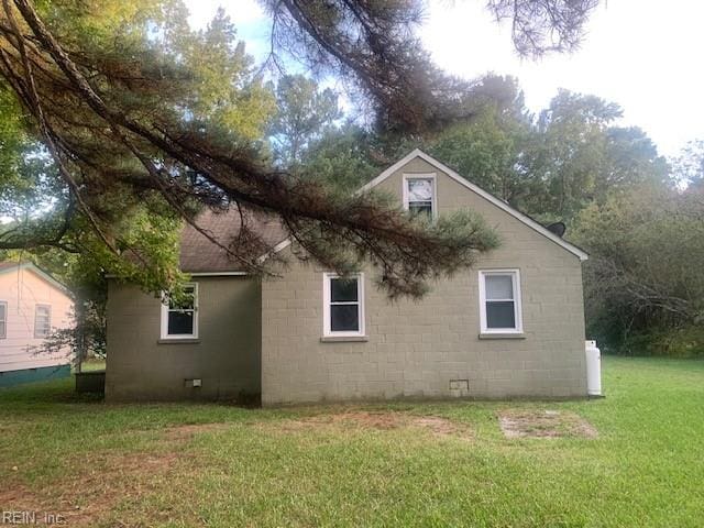 view of property exterior featuring a lawn