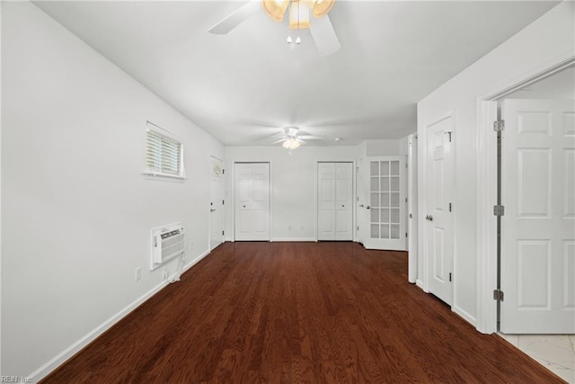 interior space featuring ceiling fan, hardwood / wood-style floors, and a wall unit AC