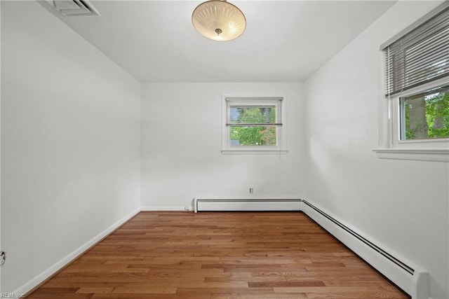 spare room featuring light hardwood / wood-style flooring and a baseboard radiator