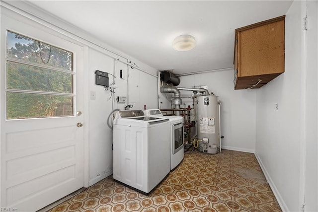 washroom with washing machine and clothes dryer, gas water heater, and cabinets