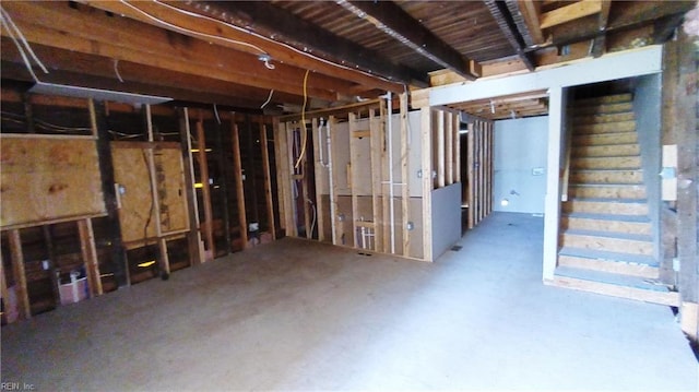 unfinished basement featuring stairway