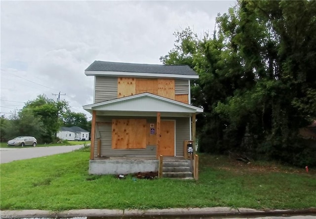 view of front of house with a front lawn and covered porch