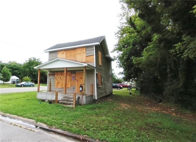 view of front of house featuring a front yard and covered porch