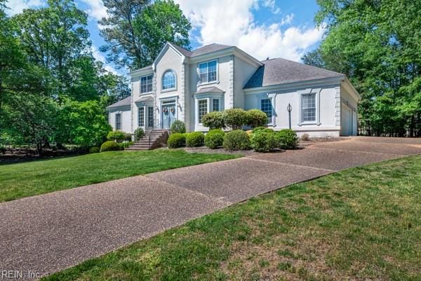 colonial-style house with a front lawn