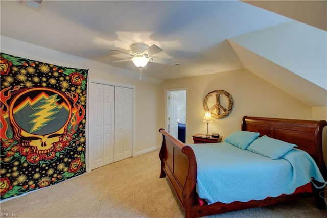 bedroom with light carpet, vaulted ceiling, ceiling fan, and a closet