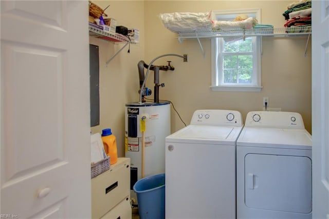 clothes washing area with washing machine and dryer and electric water heater