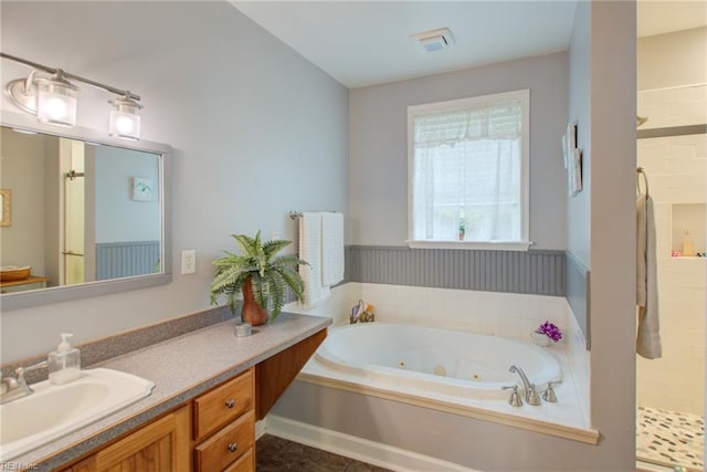 bathroom featuring independent shower and bath and vanity