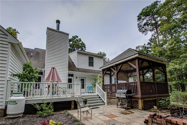 rear view of house featuring a gazebo, a patio, and a deck