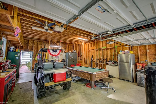 garage featuring a garage door opener, stainless steel fridge, and ceiling fan