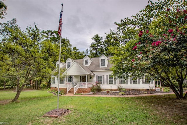 view of front of property with a porch and a front lawn