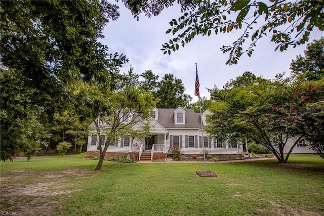 cape cod house featuring a front yard