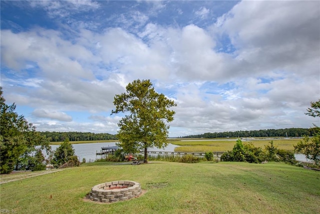 view of yard featuring a fire pit and a water view