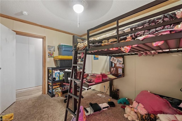 bedroom with a textured ceiling, carpet flooring, a ceiling fan, and ornamental molding