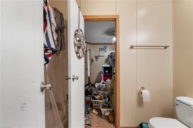 bathroom with crown molding and toilet