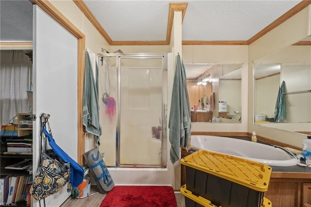 full bath with a shower with door, a textured ceiling, and crown molding