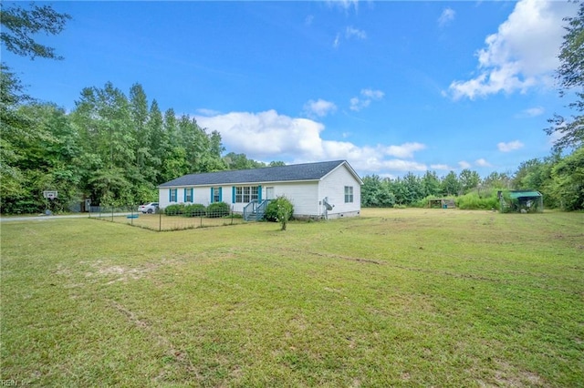 exterior space featuring a front lawn, fence, and crawl space