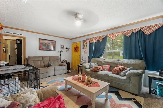 carpeted living area featuring a ceiling fan, a textured ceiling, and crown molding