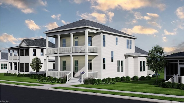 view of front of house with a balcony and a front lawn