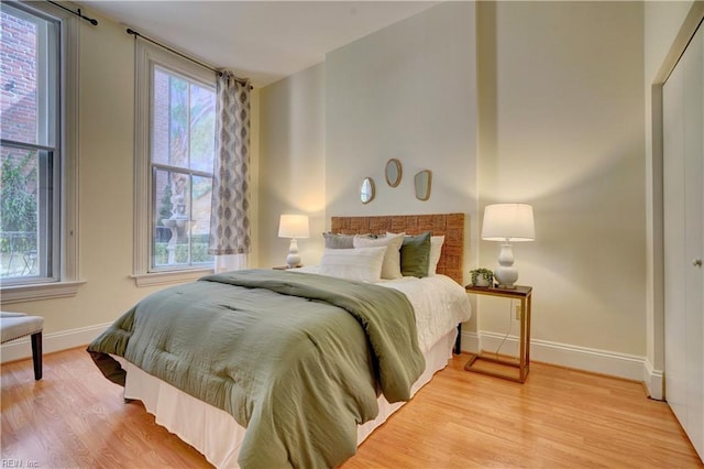 bedroom featuring light hardwood / wood-style flooring and multiple windows