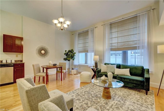 sitting room featuring a chandelier and light hardwood / wood-style floors