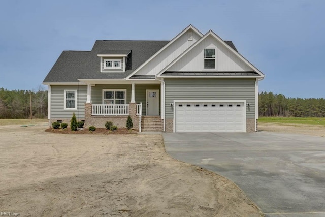 craftsman-style house featuring covered porch and a garage