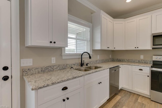 kitchen with light hardwood / wood-style flooring, appliances with stainless steel finishes, sink, white cabinetry, and light stone counters