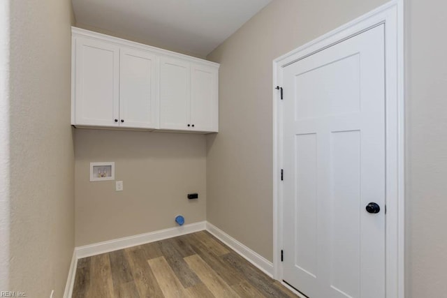 laundry area with dark wood-type flooring, cabinets, electric dryer hookup, and washer hookup