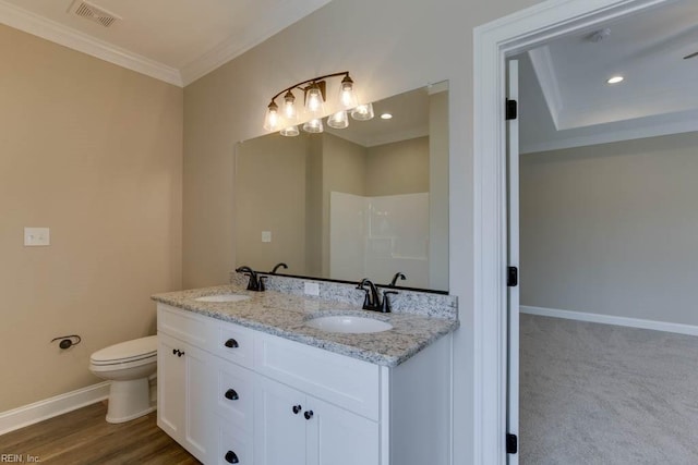 bathroom with vanity, walk in shower, toilet, ornamental molding, and hardwood / wood-style flooring