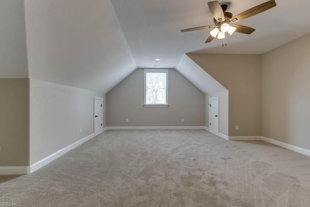 additional living space with ceiling fan, light carpet, and vaulted ceiling