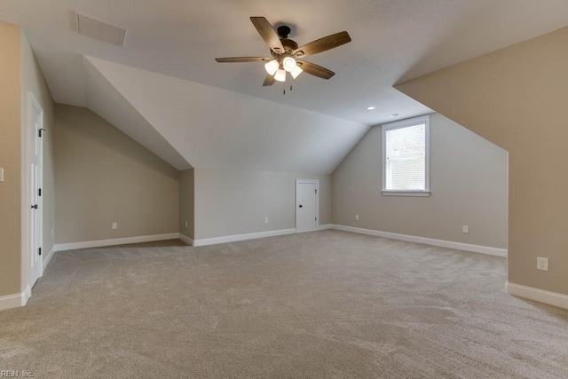 bonus room featuring lofted ceiling, ceiling fan, and light carpet