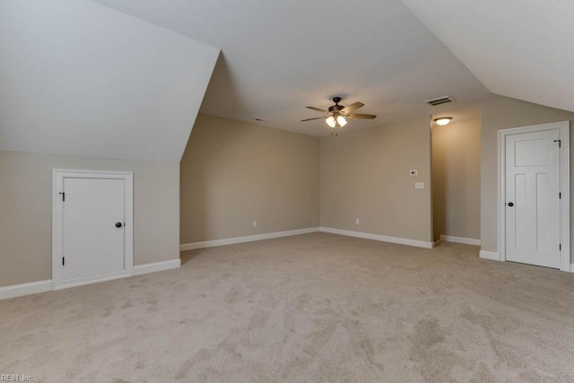 bonus room with ceiling fan, light carpet, and vaulted ceiling