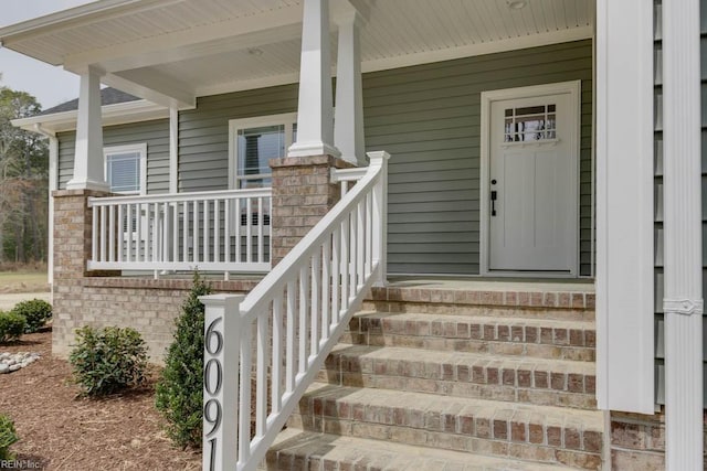 view of exterior entry with covered porch