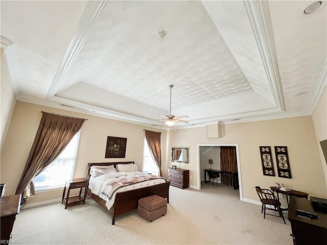 carpeted bedroom featuring crown molding, a raised ceiling, and ceiling fan