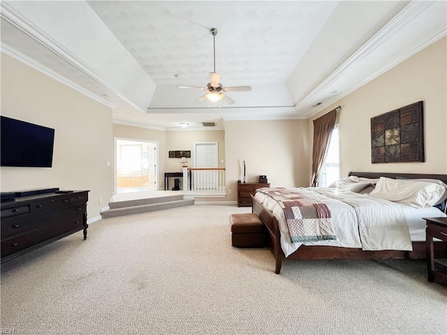 bedroom with multiple windows, ceiling fan, and a raised ceiling