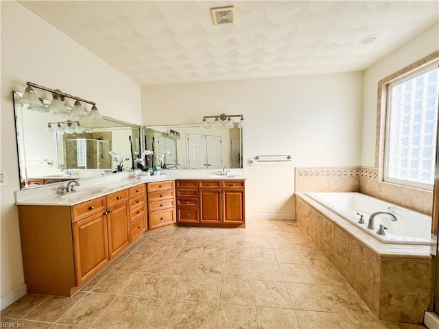 bathroom with vanity and separate shower and tub