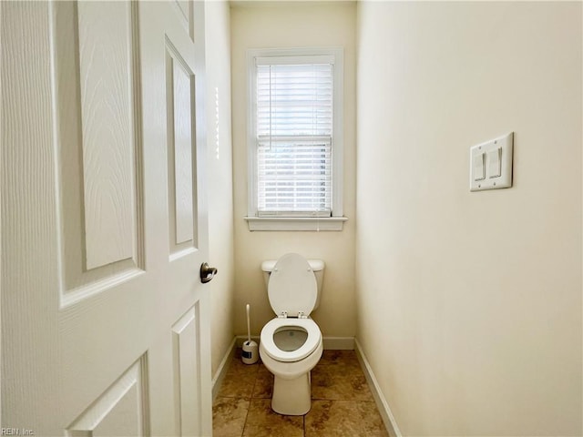 bathroom with toilet and tile patterned flooring