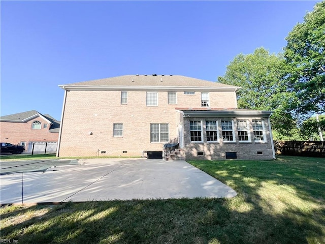 rear view of property featuring a yard and a patio area