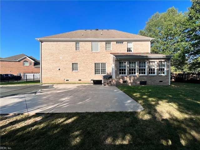 back of property featuring a lawn and a patio area