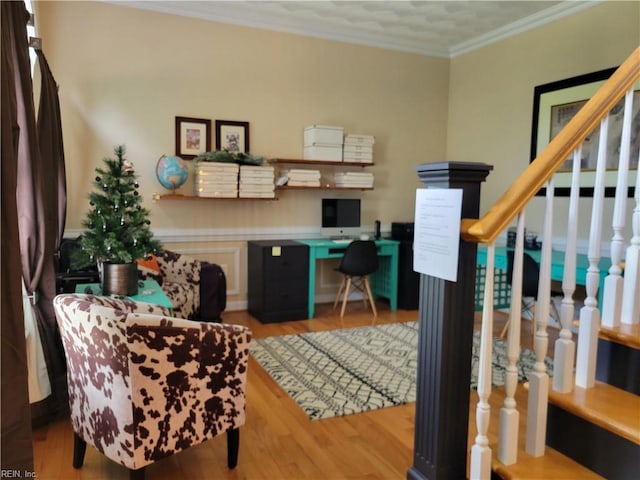 office area with ornamental molding and light hardwood / wood-style floors