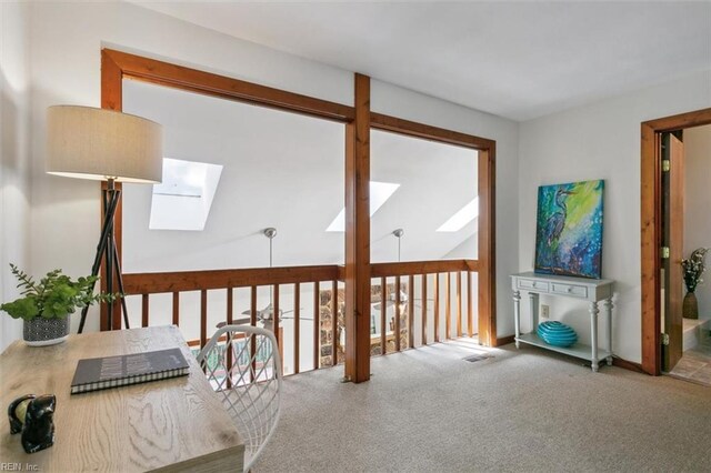 interior space with carpet flooring and a skylight