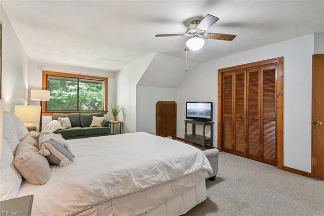 carpeted bedroom featuring lofted ceiling, ceiling fan, and a closet