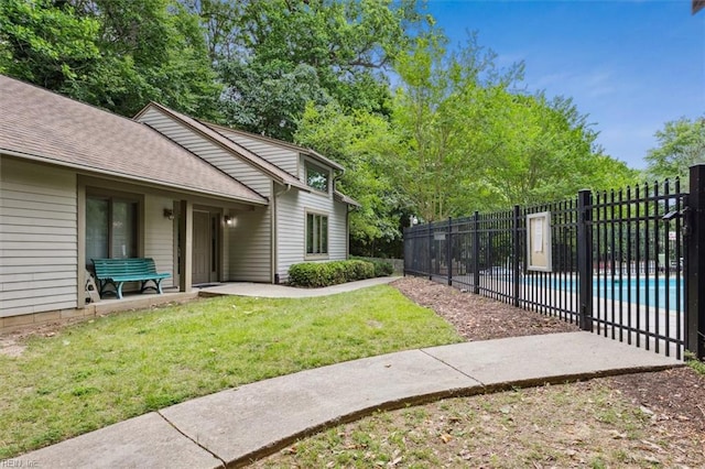 view of yard with a fenced in pool and a patio