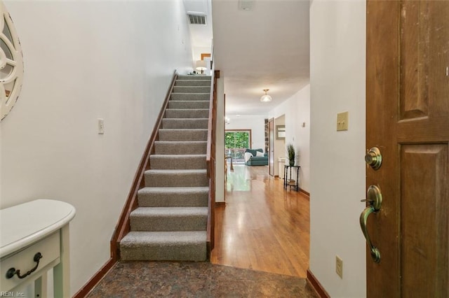 stairway featuring wood-type flooring