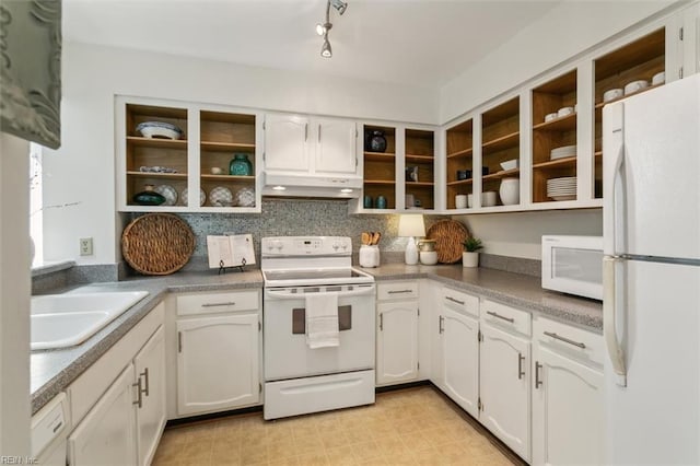 kitchen with sink, white appliances, white cabinets, and tasteful backsplash