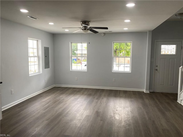 interior space featuring ceiling fan, electric panel, and dark hardwood / wood-style flooring