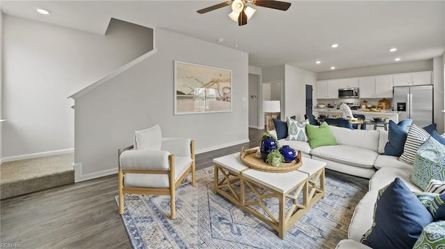 living room featuring hardwood / wood-style floors and ceiling fan