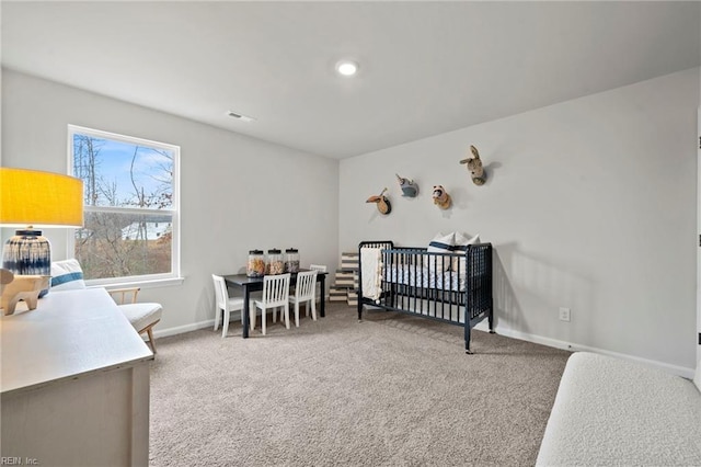 carpeted bedroom featuring a crib