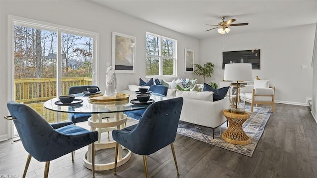 dining space featuring ceiling fan and dark hardwood / wood-style flooring